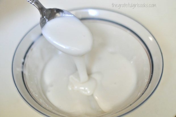 Powdered sugar icing is mixed to drizzle on gingerbread muffins.