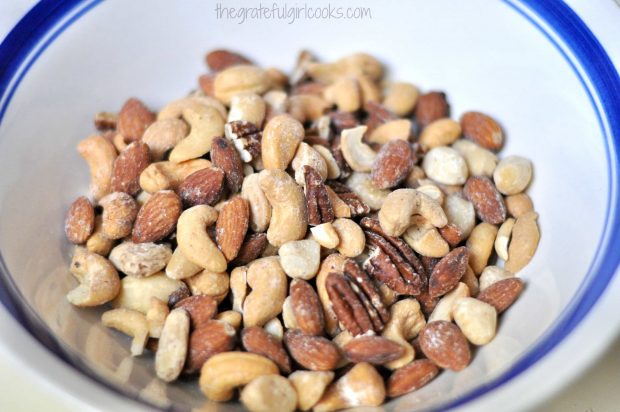 A large bowl of roasted mixed nuts in a bowl.