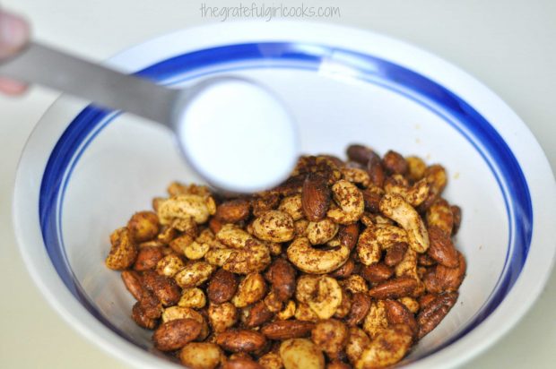 Roasted nuts are sprinkled with sugar just as soon as they are out of oven.
