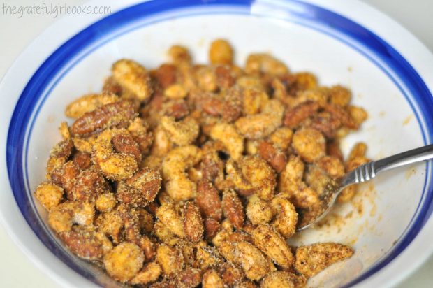 Mixed seasoned and roasted nuts are coated with spices and sugar, and are ready to serve.