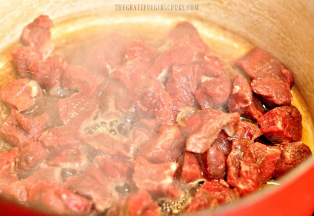 Beef chunks cooking in pan