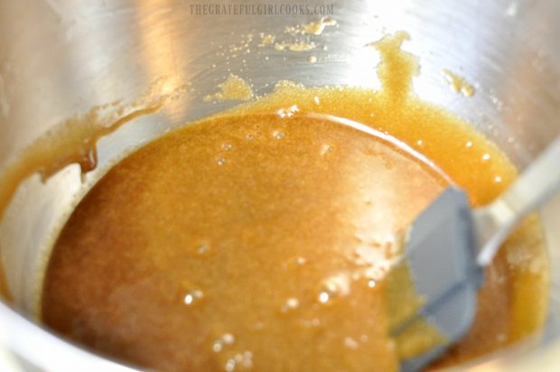 Eggs, vanilla, butter mixture in metal bowl with spatula