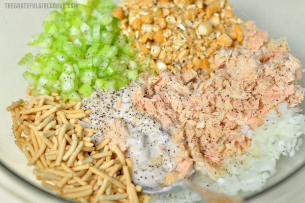 Celery, tuna, cashews, chow mein noodles in bowl for casserole.