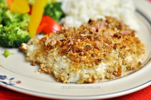 The pecan crusted halibut is drizzled with lemon wine sauce and served.