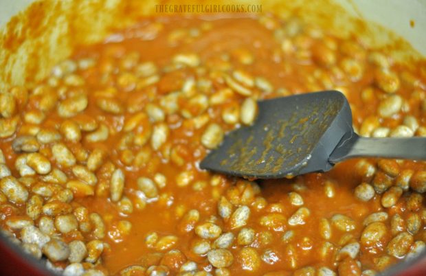Prepared pinto beans are added to the sauce.