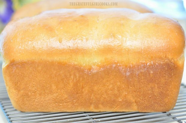 Side view of white bread loaf on wire rack