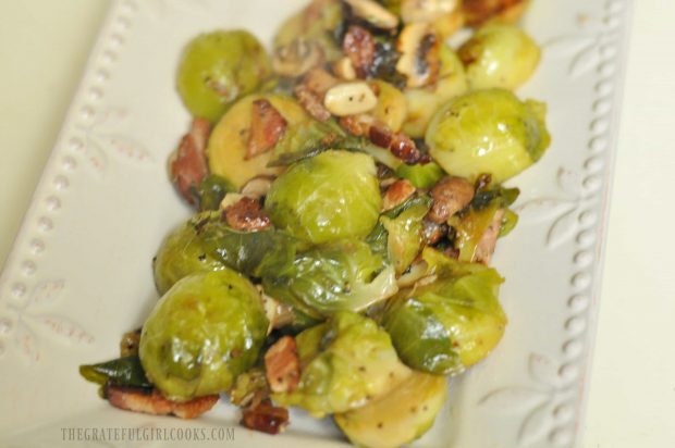 Brussel Sprouts with Bacon and Mushrooms are served on white platter.
