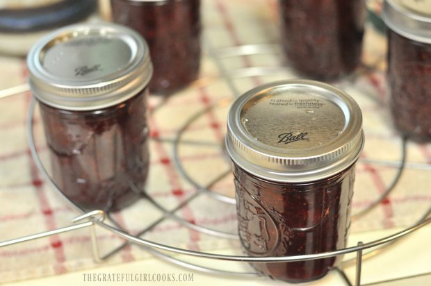 Jars of strawberry jam on canning rack