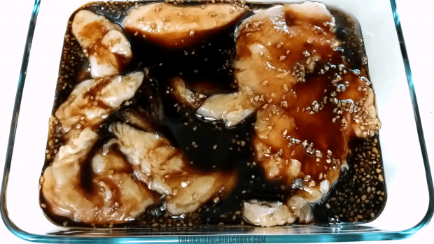Chicken pieces are placed in teriyaki sauce in a dish, then refrigerated while they marinate.