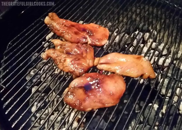 Grilling the teriyaki chicken with homemade sauce on a BBQ grill.