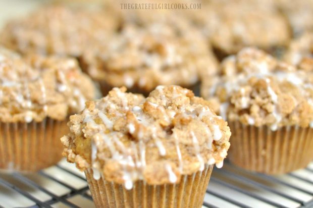 Glaze is decoratively drizzled over baked muffins