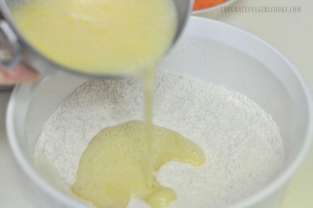 Eggs poured into dry ingredients in white bowl