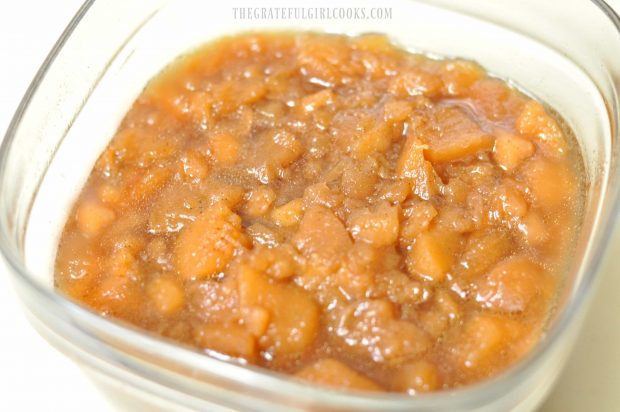 Chunky crock pot apples in dish are partially mashed before serving.