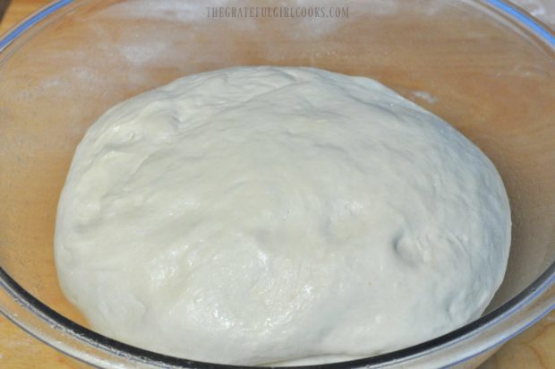 Dough ball for English muffins is placed into large greased bowl to rise.