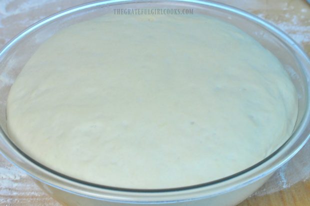 Dough for English muffins has doubled in size in mixing bowl.