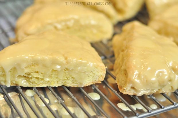 Lemon cream scones, on wire rack with lemon glaze dripping down