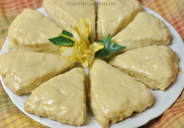 Lemon cream scones, served on white plate with yellow flower on top