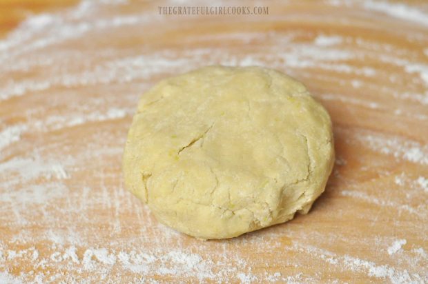Lemon scone dough is formed into a ball on floured surface