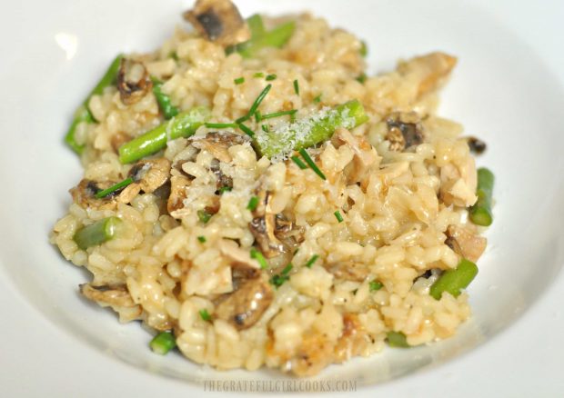 Chicken and asparagus risotto is garnished with Parmesan cheese and chives