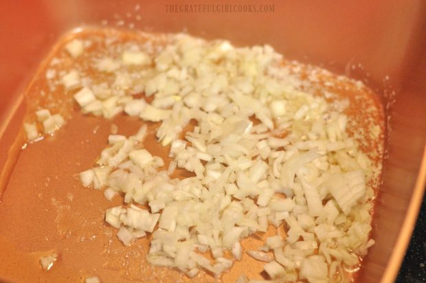 Chopped onion is cooked in butter and olive oil for risotto
