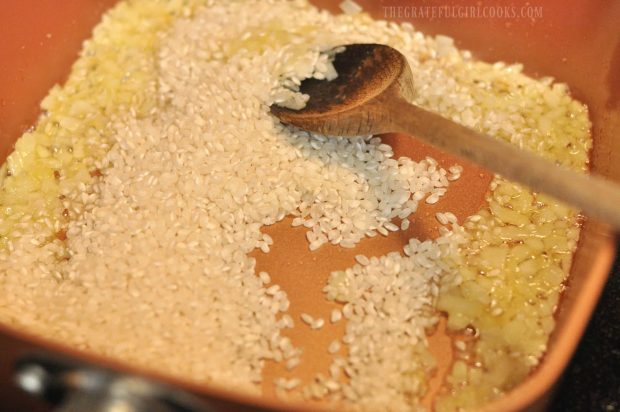 Arborio rice is added to cooked onions for risotto