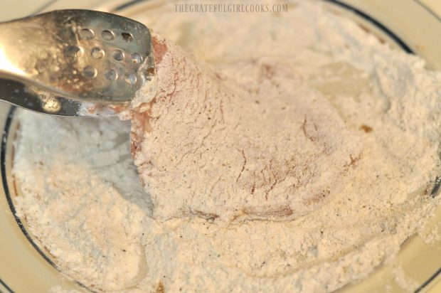 Pork cutlets are dredged in flour/spice mixture until covered, before cooking.