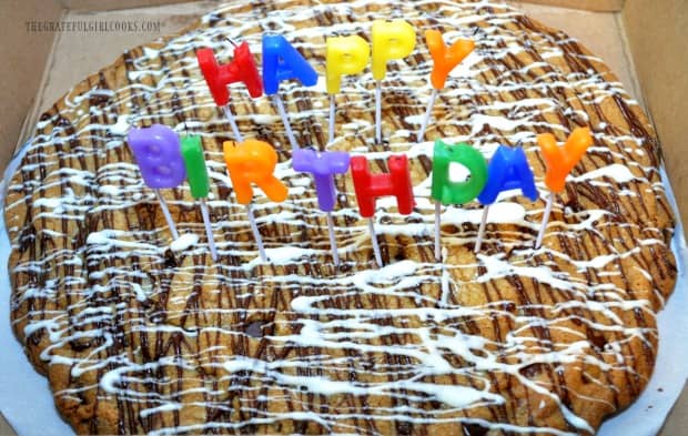 The chocolate chip cookie pizza, decorated with chocolate icing, and birthday candles!