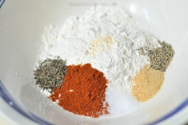 Spices are mixed together in bowl, for shake and bake chicken.