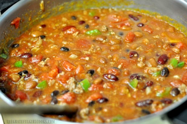 Lots of spices, beans, and tomatoes are added to the chili.