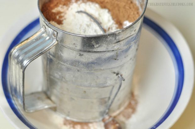 Flour, cocoa, and other dry ingredients sifted for chocolate cake batter