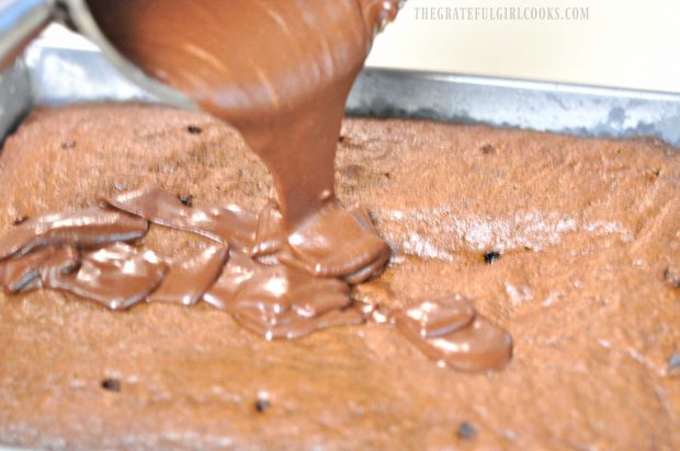 Chocolate frosting poured over baked cake