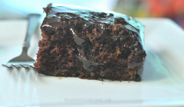 Piece of Mom's chocolate cake on white plate with fork