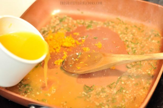 Orange juice being added to skillet for glaze