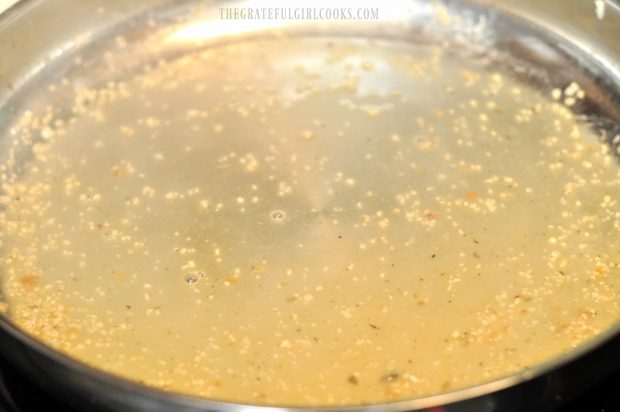 Garlic, lemon juice and white wine are added to skillet to make sauce for the fish.