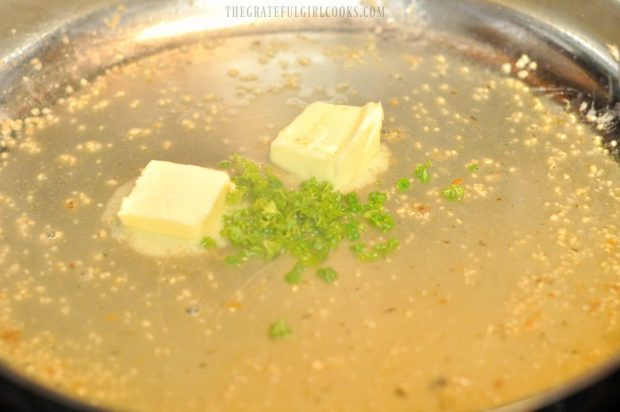 Butter and fresh parsley is added to the sauce in skillet.