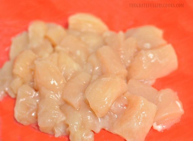 Chicken breasts are cut into cubes to cook for the chicken veggie stir fry.