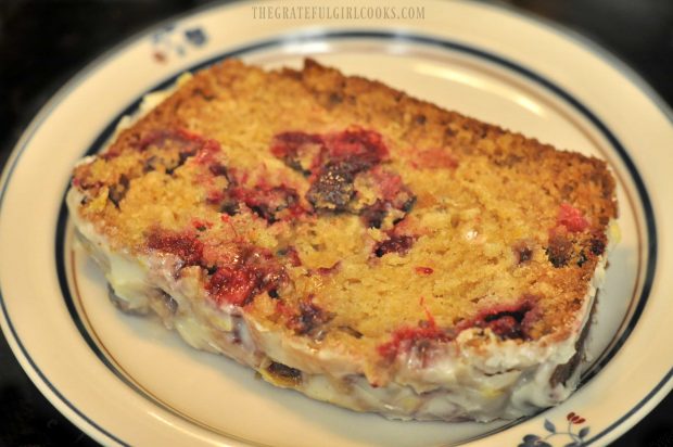 Cranberry orange loaf slice on a plate, ready to eat!