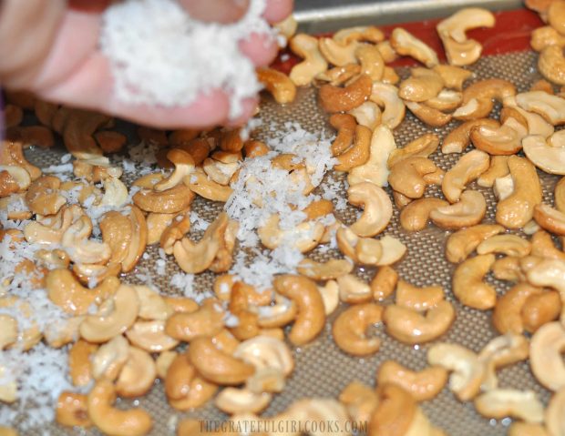 Finely shredded coconut flakes are added to coconut candied cashews, then baked.