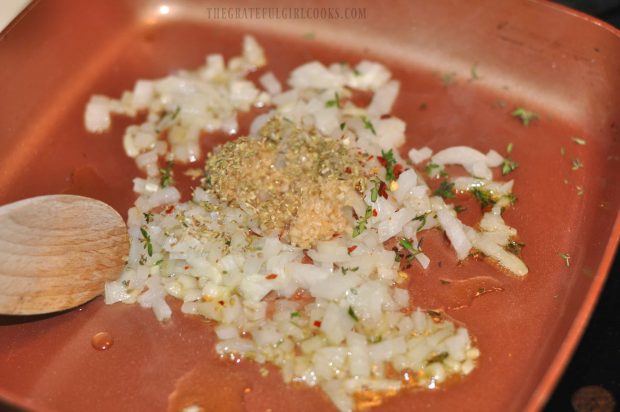 Chopped onion, minced garlic and spices cook in skillet before adding other ingredients.