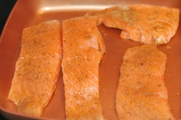 The seasoned salmon fillets are pan seared.