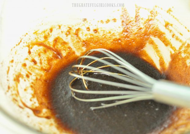 Mixing molasses with spices to make gingerbread granola.