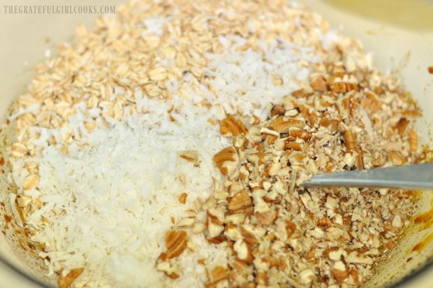 Oats, coconut and chopped nuts are ready to add to the gingerbread granola mixture.