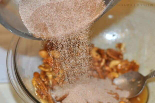 Mixed nuts are coated with cinnamon, sugar and spice mixture