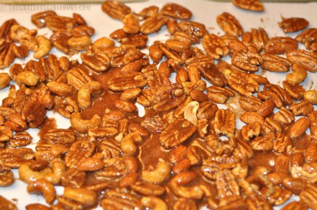 Maple cinnamon coated spiced nuts are spread out to bake