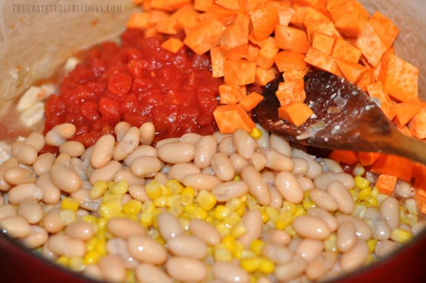 White beans, corn, sweet potato and tomatoes are added to the chicken peanut stew.