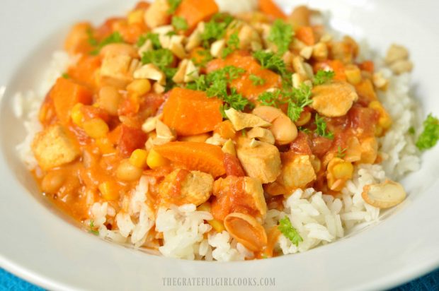 The West African Chicken Peanut Stew is garnished with parsley and peanuts, and served on rice.