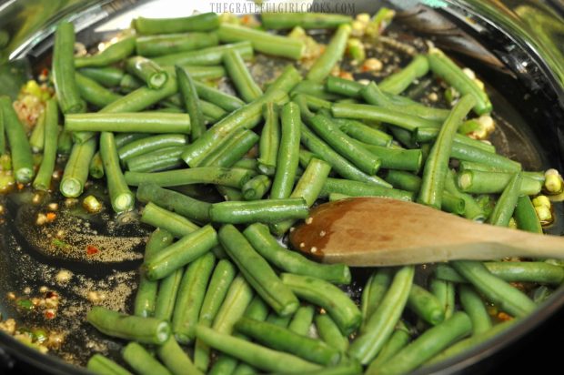 Green beans are added to the skillet.