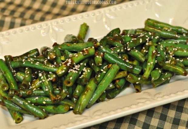 Sesame seeds garnish the serving plate covered with P.F. Chang's Spicy Green Beans.