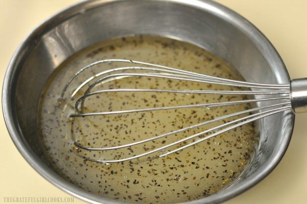 Dressing for bean salad is whisked together in bowl