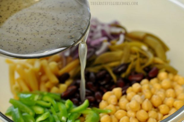 Dressing for 4 bean salad is poured on ingredients